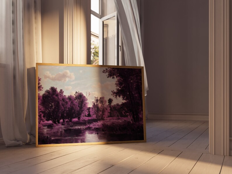 May include: A framed landscape painting with a gold frame. The painting depicts a river scene with trees and a cloudy sky. The colors are muted and the scene is peaceful.