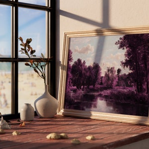 May include: A framed painting of a landscape with a river and trees in shades of purple and blue, hanging on a wall next to a window with a view of a beach.