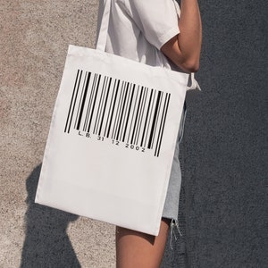 Peut inclure: Sac fourre-tout blanc avec un code-barres noir et le texte "L.B. 31 12 2002" imprimé dessus.