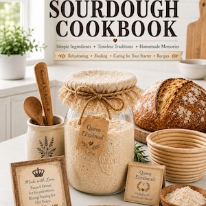 May include: A glass jar filled with sourdough starter, topped with a burlap cover and a tag labeled Queen Elizabread. Beside it are a wooden spoon, a loaf of bread, a proofing basket, a bowl of flour, and signs with text including Queen Elizabread's Sourdough Cookbook.