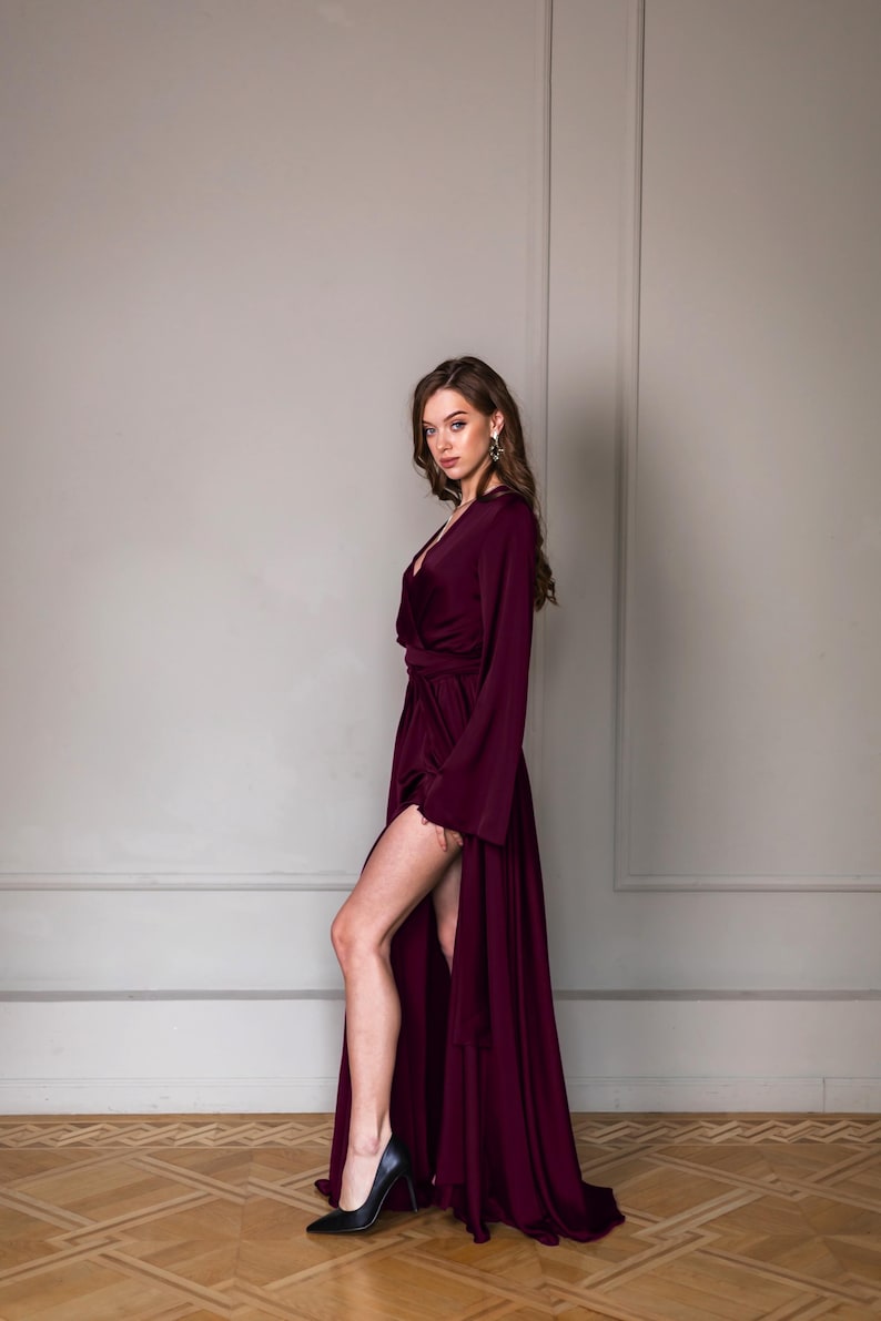 a woman in a long dress posing for a picture