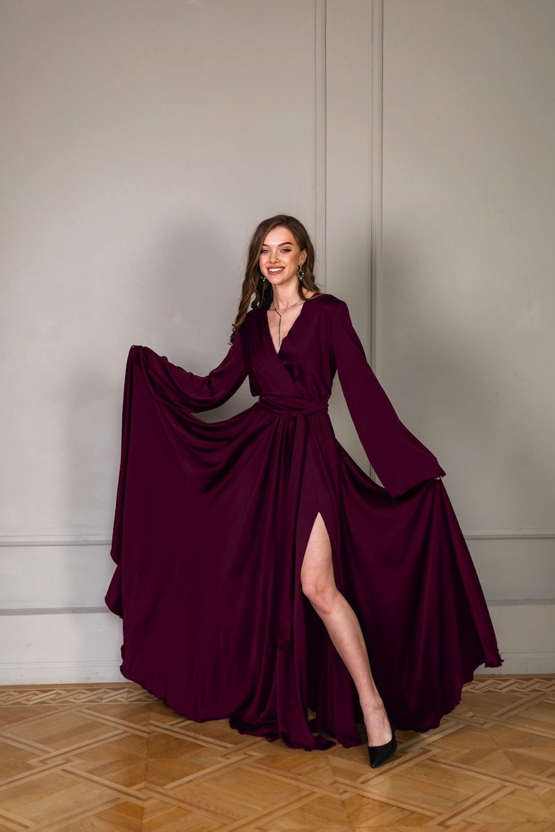 a woman in a purple dress posing for a picture