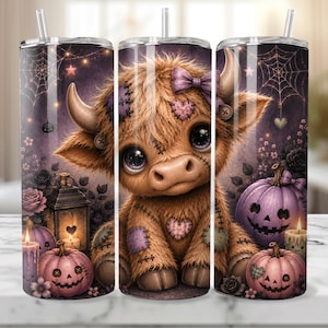 May include: A cylindrical tumbler featuring a fluffy brown highland cow with stitched patches, a purple bow, and large eyes. The design includes purple pumpkins, a lantern, candles, spiderwebs, and stars against a dark purple background.