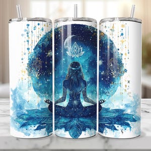 May include: A stainless steel tumbler with a blue and gold watercolor design featuring a woman meditating in front of a crescent moon and a lotus flower. The design is surrounded by stars and a mandala pattern.
