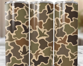 May include: Three stainless steel insulated tumblers with a camouflage pattern in shades of brown, tan, and green. Silhouettes of flying ducks are scattered across the design. Each tumbler has a clear lid and a reusable straw.
