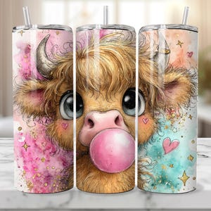 May include: A set of three stainless steel insulated tumblers. Each tumbler features a watercolor illustration of a Highland cow blowing a bubblegum bubble. The design includes pink, teal, and gold accents with hearts and stars.