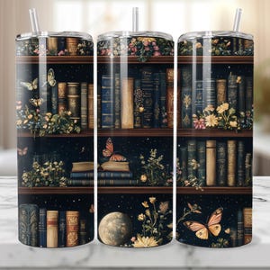 May include: Three stainless steel tumblers with a dark blue background featuring a bookshelf filled with books, flowers, butterflies, and a moon. The tumblers are perfect for holding hot or cold beverages.