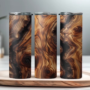 May include: Three stainless steel tumblers with a wood grain pattern. The tumblers are brown and black with a swirling wood grain design.