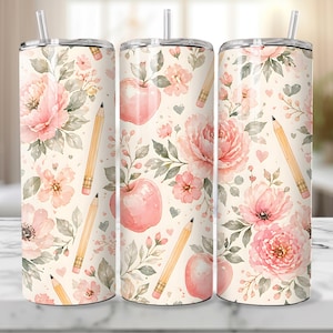 May include: A floral-themed tumbler featuring a repeating pattern of pink peonies, apples, pencils, and hearts on a cream background. The design includes watercolor-style illustrations with a straw and a silver lid.