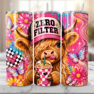 May include: A set of three stainless steel tumblers with a vibrant design. Each tumbler features a whimsical illustration of a Highland cow wearing a "Zero Filter" cap, holding a drink, and surrounded by butterflies and flowers. The tumblers have a straw.