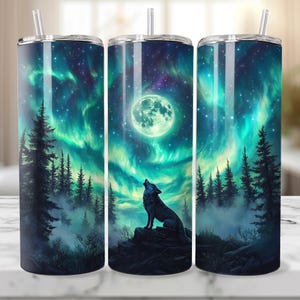 May include: A stainless steel tumbler with a wolf howling at the moon in a forest scene. The background is a dark blue with green and purple aurora borealis.