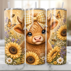 May include: A cylindrical tumbler with a straw featuring a graphic of a fluffy highland cow wearing a yellow and white gingham bow. The design includes sunflowers, lavender, daisies, bees, and monarch butterflies on a golden, sparkling background.