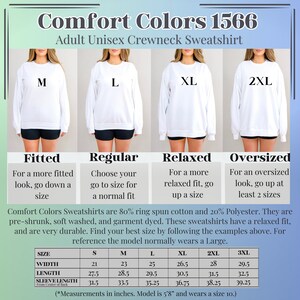May include: Size chart for a unisex crewneck sweatshirt in Comfort Colors 1566. The chart shows the width, length, and sleeve length in inches for sizes S, M, L, XL, 2XL, and 3XL. The model is 5'8" and wears a size 10.