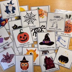 May include: A set of 16 Halloween-themed game cards with colorful illustrations and text. The cards feature activities like "Cast a Spell", "Broom Ride", "Mummy Shuffle", and "Trick or Treat".