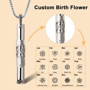 May include: A silver necklace with a small, cylindrical pendant that can be personalised with a birth flower. The pendant has a cutout design of a flower and a small rhinestone. A chart shows the birth flower for each month of the year.