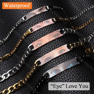 May include: Several waterproof bracelets with chain links. Each bracelet has a rectangular plate with a close-up image of an eye. The text "Eye Love You" is visible.