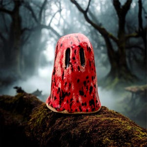 May include: A white ceramic mug with a black handle and the text "But First, Coffee" in a handwritten style. The mug is on a white surface. The mug is 4 inches tall.