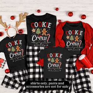 May include: Black "Cookie Crew" shirts with Christmas graphics and names, paired with black and white plaid pajama pants. Festive red accents include ornaments and a cardigan. Reindeer antlers and candy canes add to the holiday theme.