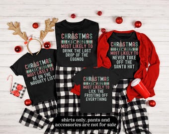 May include: Four black Christmas crew t-shirts with festive text and a Christmas tree graphic. The shirts have phrases like "Most Likely to Be on the Naughty List" and "Most Likely to Drink the Last Drop of the Eggnog". Red accents and plaid pajama pants are also visible.