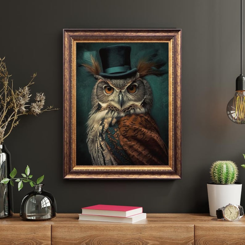 May include: A framed print of an owl wearing a top hat. The owl has brown and white feathers and is looking directly at the viewer. The background is a dark teal color.