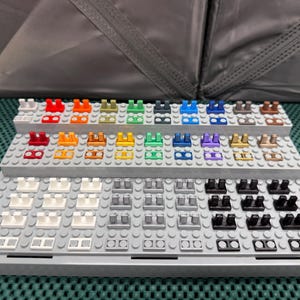 May include: A white ceramic mug with a black handle and the text "But First, Coffee" in a black, bold font. The mug is sitting on a wooden surface. The mug is approximately 4 inches tall.