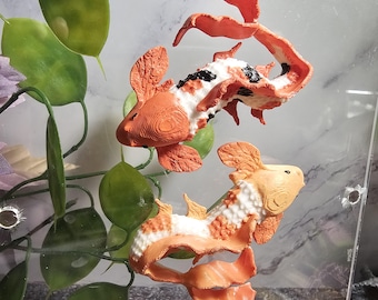 Plataformas de araña saltarina con forma de pez koi magnético impresas en 3D