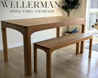 May include: A wooden dining table and bench set. The table and bench are made of light brown wood. The table has a rectangular top and curved legs. The bench is a smaller version of the table. The text "THE WELLLERMAN DINING TABLE AND BENCH" is at the top.