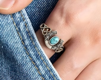Peut inclure: Bague en argent avec une pierre turquoise sertie dans un motif de fer à cheval.