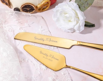 May include: Gold wedding cake knife and server set with the names "Geraldly & Jorian" and the date "01.07.2024" engraved on the handles.