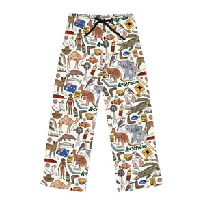 May include: White pajama pants with a repeating pattern of Australian icons, including kangaroos, koalas, boomerangs, and the word "Australia".