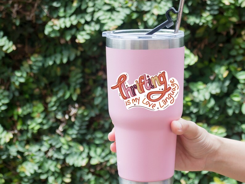 May include: Pink stainless steel tumbler with a sticker that says "Thrifting is my love language".