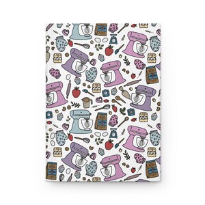 May include: A white background with a repeating pattern of kitchen tools and appliances in pink, blue, and green. The pattern includes stand mixers, measuring cups, spoons, rolling pins, and other baking supplies.