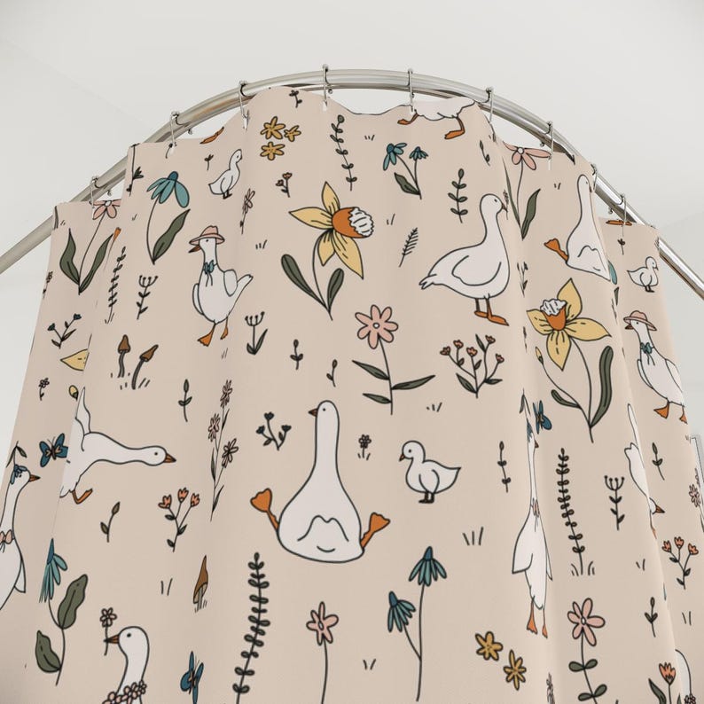May include: A beige shower curtain with a repeating pattern of white geese, yellow daffodils, and green leaves.