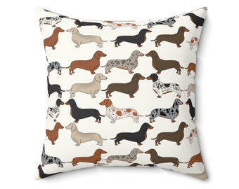 May include: A white throw pillow with a repeating pattern of dachshund dogs in various colors and patterns. The dogs are all facing forward and have their tongues sticking out.
