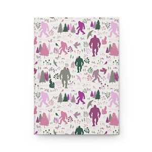 May include: A white background with a repeating pattern of pink, purple, and green silhouettes of Bigfoot, trees, and birds.