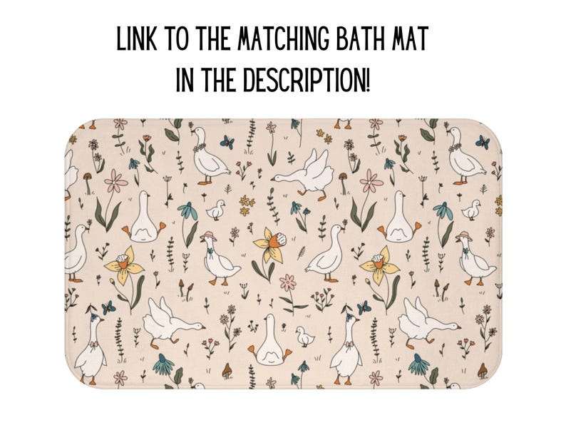 May include: A beige bath mat with a repeating pattern of white geese, flowers, and leaves. The geese are facing different directions and have small black eyes. The flowers are in shades of pink, yellow, and blue. The leaves are green.