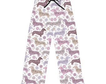 May include: White pajama pants with a pattern of brown, pink, and purple dachshunds with floral details.