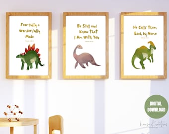 May include: Three printable wall art prints featuring watercolor illustrations of dinosaurs with inspirational quotes in gold lettering. The prints are framed in wood and have a white background. The quotes are "Fearfully & wonderfully made", "Be still and know that I am with you", and "He calls them each by name".