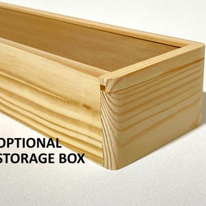 May include: A natural wood storage box with a lid. The box is made of light wood with a natural finish. The box is labeled "OPTIONAL STORAGE BOX".
