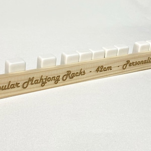 May include: White wooden mahjong racks on a wooden base with the text "Cubular Mahjong Racks - 42cm - Personalize Me".
