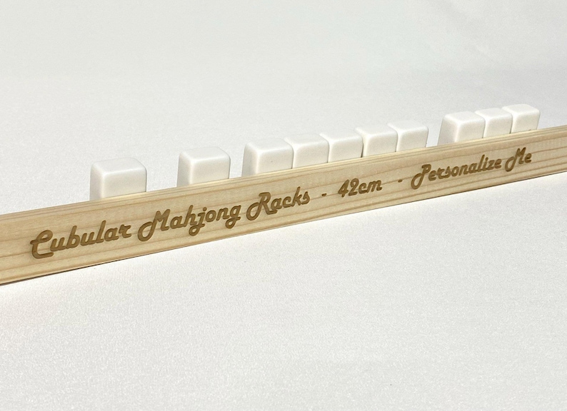 May include: White wooden mahjong racks on a wooden base with the text "Cubular Mahjong Racks - 42cm - Personalize Me".