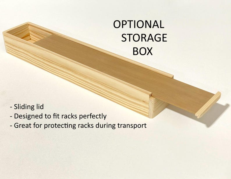 May include: A wooden storage box with a sliding lid. The box is designed to fit racks perfectly and protect them during transport. The text "OPTIONAL STORAGE BOX" is printed on the box.