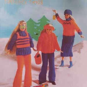 May include: A knitting pattern for trendy gear for fashion dolls. The pattern includes instructions for a blue and orange ski outfit, a red sweater and blue pants, and a blue and orange sweater and skirt. The pattern is for dolls that are 28 cm (11 inches) tall.