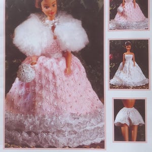 May include: A pink knitted doll dress with a white fur shawl and a white lace trim. The dress is decorated with small white beads. The doll is holding a white beaded purse. The image also shows a white knitted doll dress and a white knitted doll skirt.