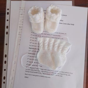 May include: Knitting pattern instructions for making baby booties. The pattern includes instructions for shaping the instep and knitting the ankle. The pattern is written in English.