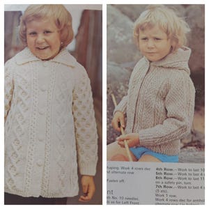 May include: Two children wearing white knitted cardigans with cable knit patterns. The cardigan on the left has a button closure and the cardigan on the right has a zipper closure. Both cardigans have a hood.
