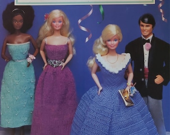 May include: A vintage McCall's Craft Book cover titled "Fashion Doll Wardrobe Vol. 3." The cover features four dolls, three women and one man, dressed in handmade knitted and crocheted gowns and formal wear. The background is blue with decorative streamers.