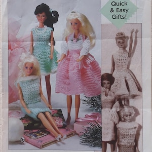 May include: A page from a magazine featuring several Barbie dolls in handmade crochet outfits. The dolls are wearing dresses in shades of pink, blue, and white. The text "Quick & Easy Gifts!" is visible, along with "Christmas 1964".