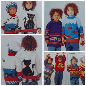 Pode incluir: Camisolas de malha para crianças com vários desenhos. Uma camisola apresenta um gato preto, outra tem uma paisagem azul com peixes, e outras mostram animais e padrões. As camisolas são em várias cores, incluindo branco, azul e vermelho.