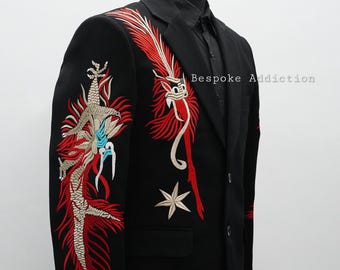 May include: A black blazer with red and gold embroidery of a dragon on the left sleeve and a star on the right side. The text "Bespoke Addiction" is visible on the right side of the blazer.